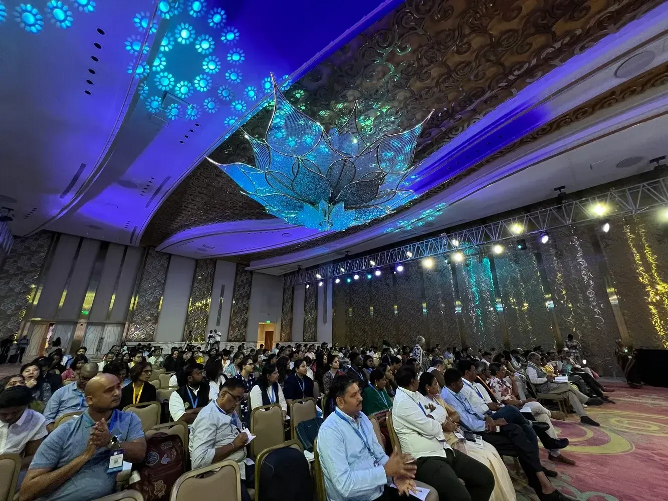 The audience in the hall listening to the presentation